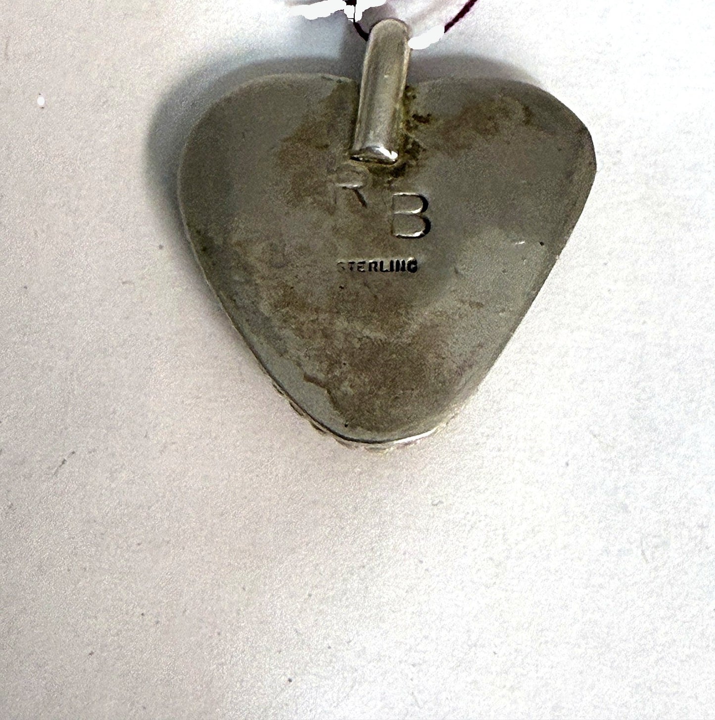 Back of the fire agate heart pendant, hand-signed RB and STERLING