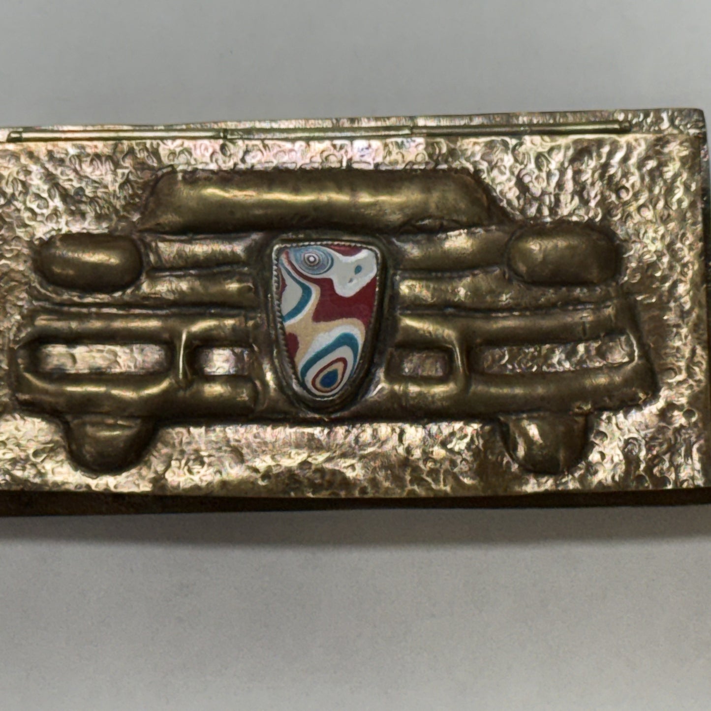 Repoussé brass box hand-sculpted as a 1950s car grille with a fordite badge