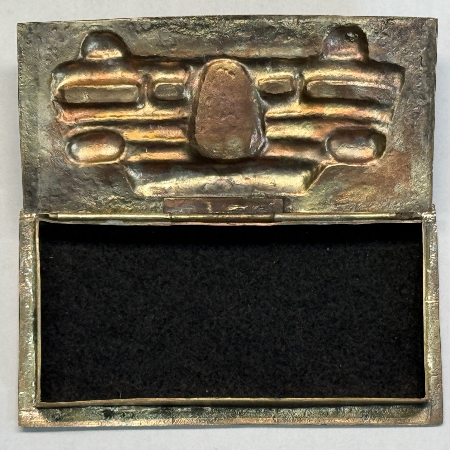 Brass box open showing the felt-lined interior