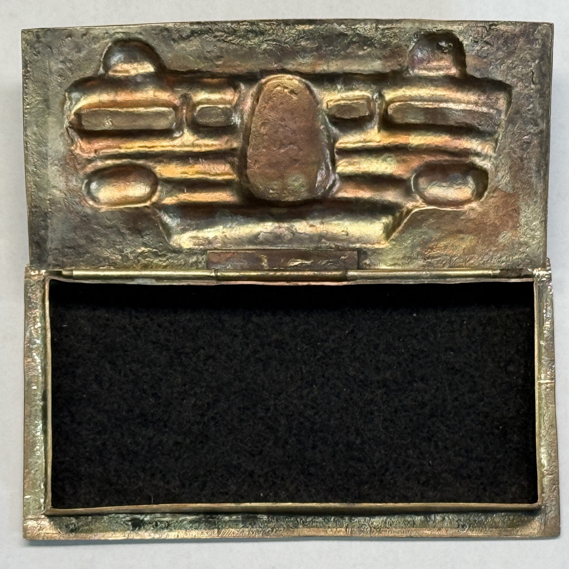 Brass box open showing the felt-lined interior