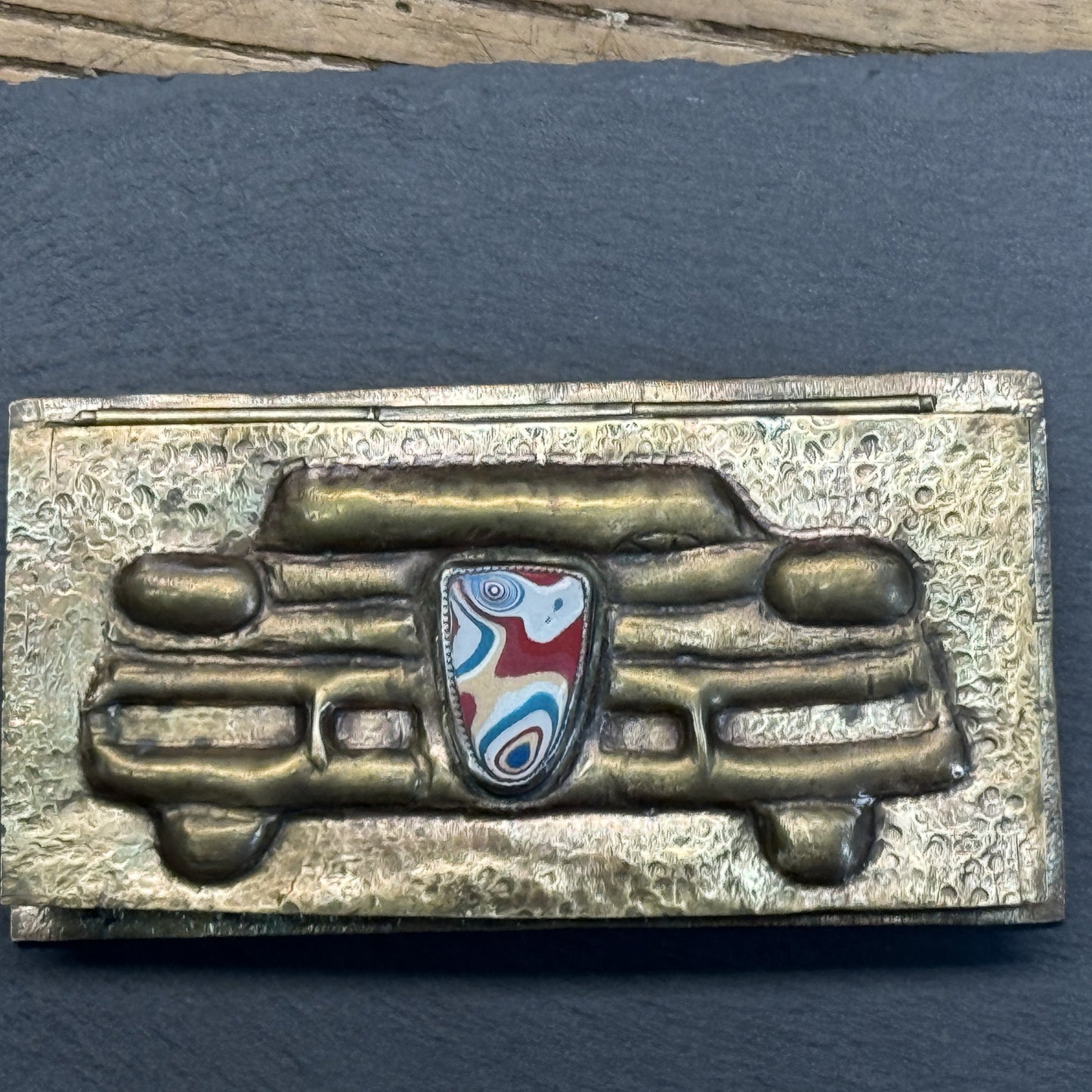 Repoussé brass fordite box styled in a set
