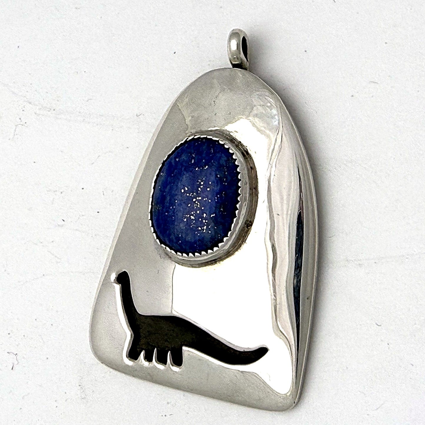Sterling silver sauropod dinosaur pendant with lapis lazuli cabochon, front view