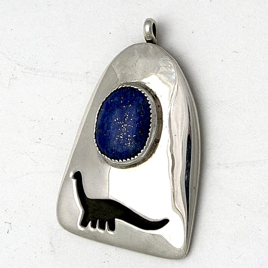 Sterling silver sauropod dinosaur pendant with lapis lazuli cabochon, front view