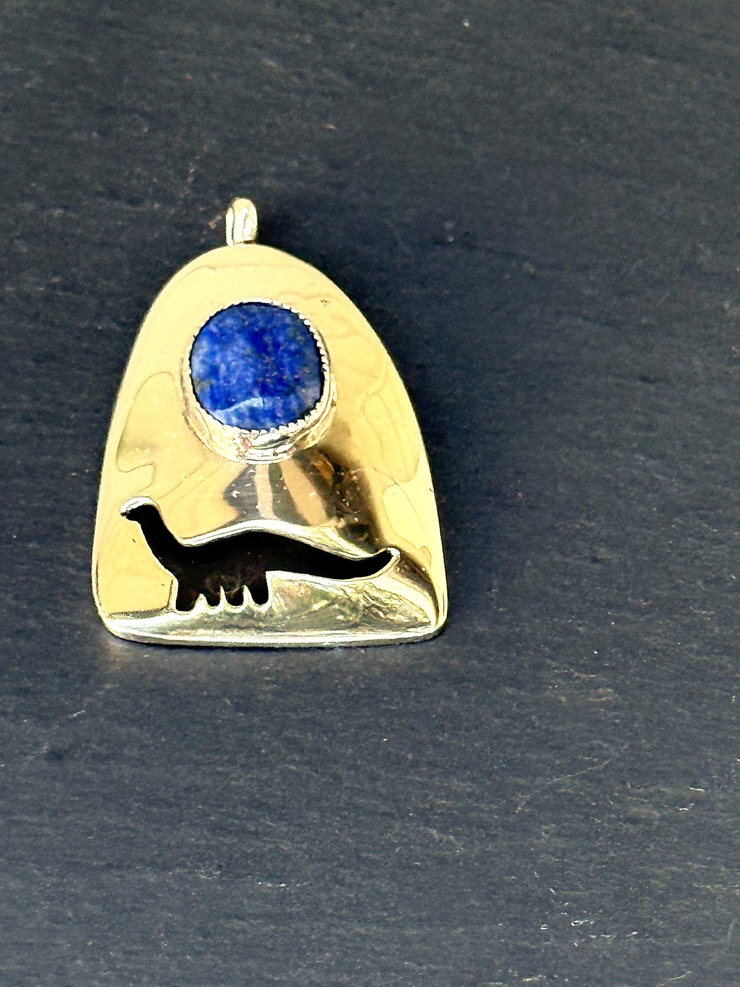 Sterling silver dino-lapis pendant styled on slate