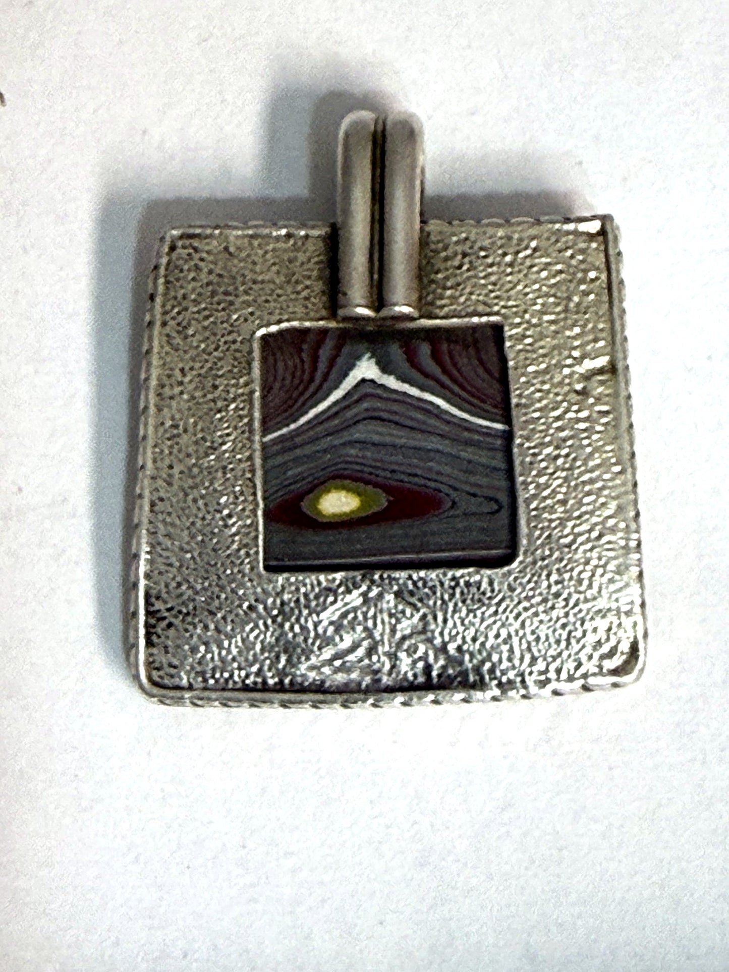 Open-back shadowbox window showing the reticulated silver back
