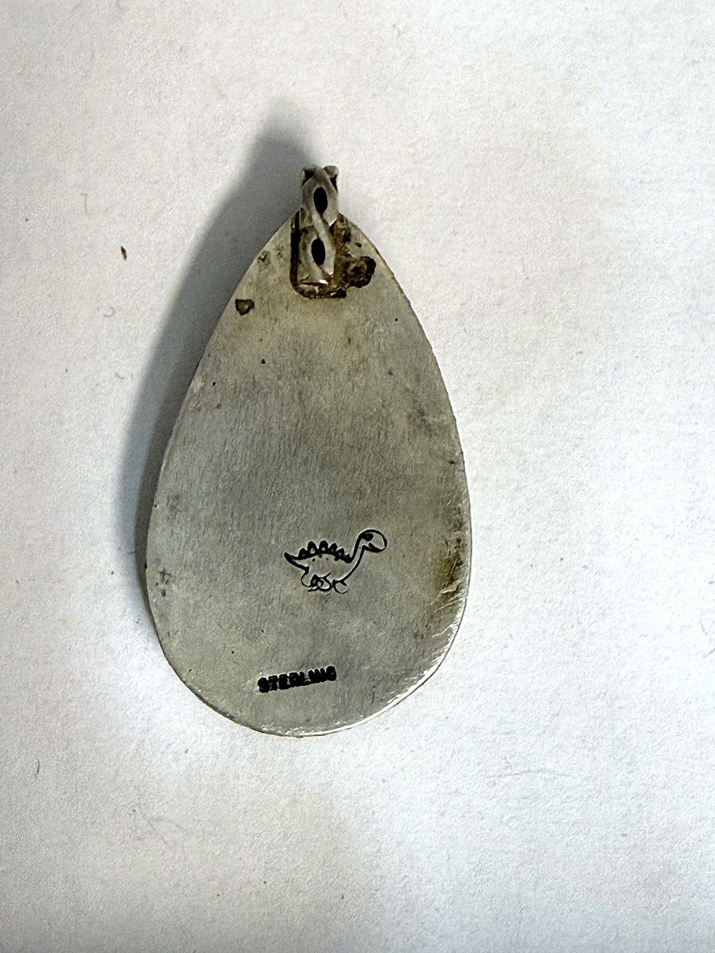 Hand-finished back stamped STERLING with the dinosaur maker's mark