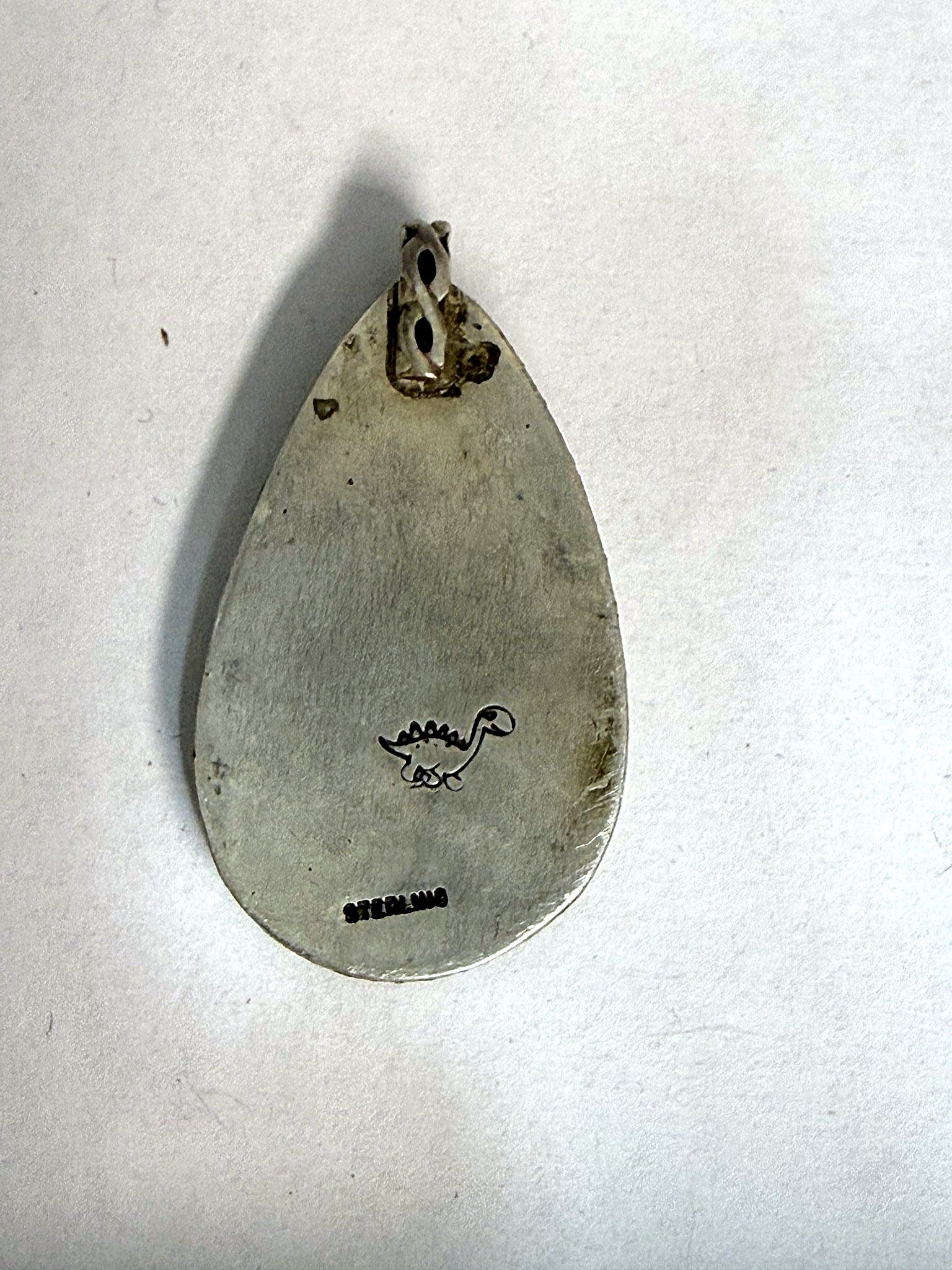 Hand-finished back stamped STERLING with the dinosaur maker's mark