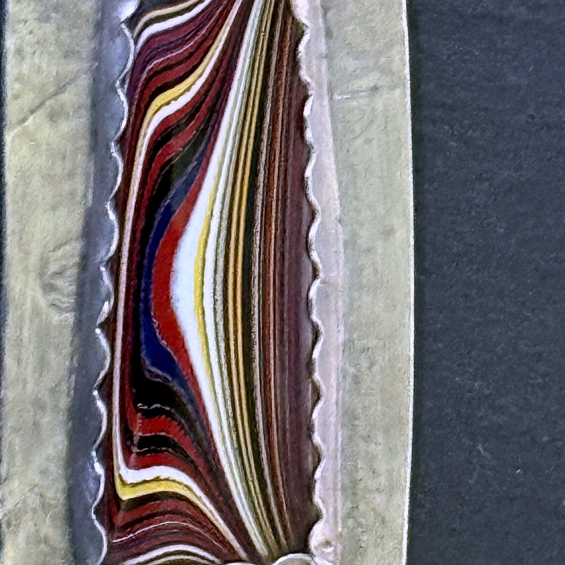 Detail of the layered fordite cabochon
